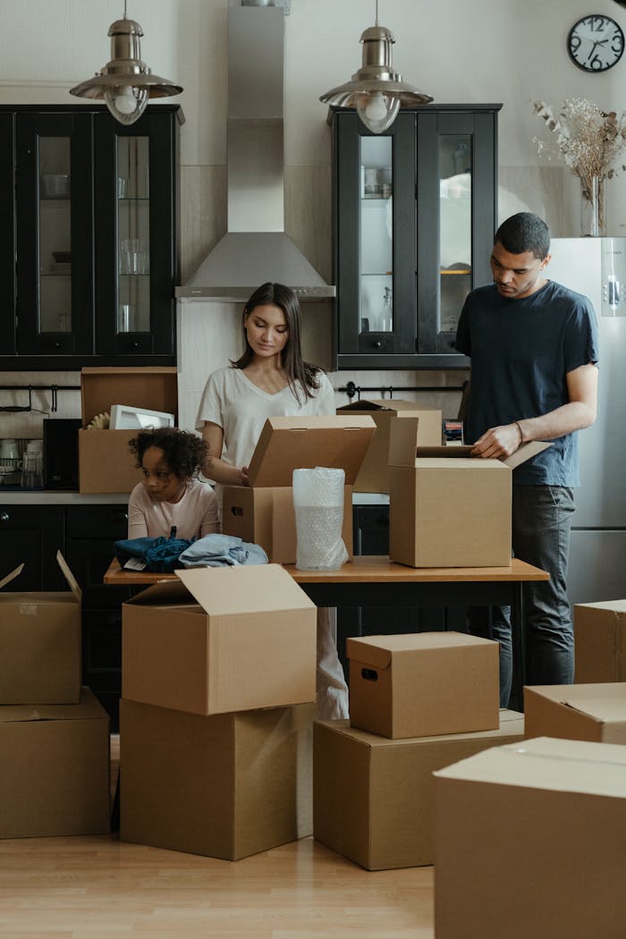 The Art of Drawing Readers In: Your attractive post title goes here Family unpacking boxes together in a modern kitchen after moving into a new home.